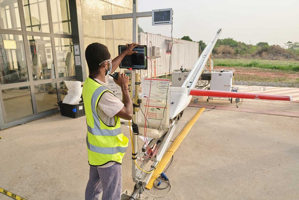 Le 2 mars, le centre de santé d'Asuofua, dans la région d'Ashanti au Ghana, est devenu le premier centre de santé au monde à recevoir un lot de vaccins COVID-19 par drone. Les doses de COVAX, qui étaient arrivées à Accra une semaine plus tôt dans le cadre d'une cargaison de 600 000 vaccins fabriqués par le Serum Institute of India, ont été collectées par des agents de santé après un largage en parachute précisément ciblé. À la fin de la journée, Zipline, le premier service de livraison de drones à l'échelle nationale, avait largué un total de 36 livraisons de vaccins COVID-19, facilitant ainsi 4 500 vaccinations.